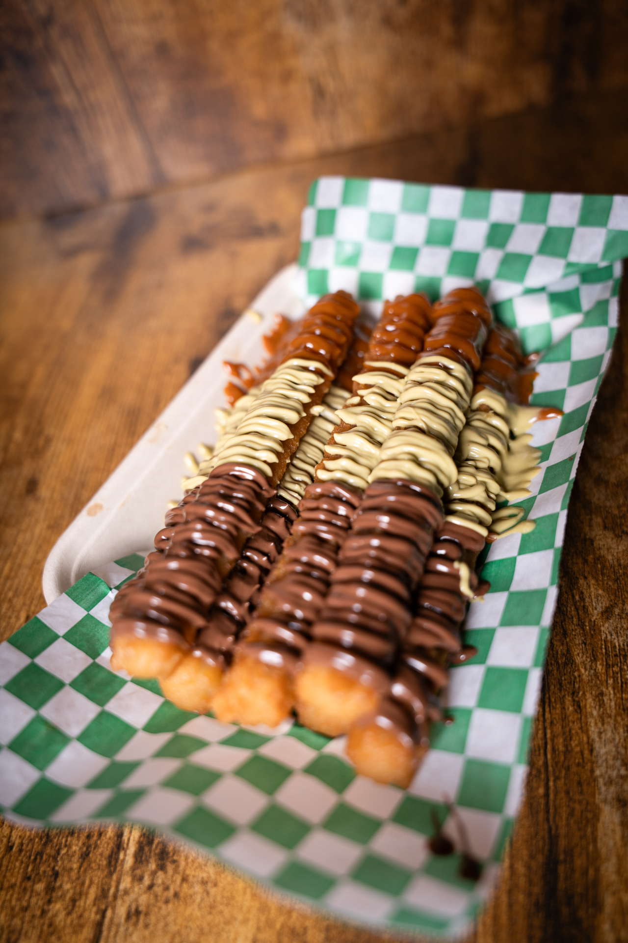Chocolate and vanilla drizzled churros