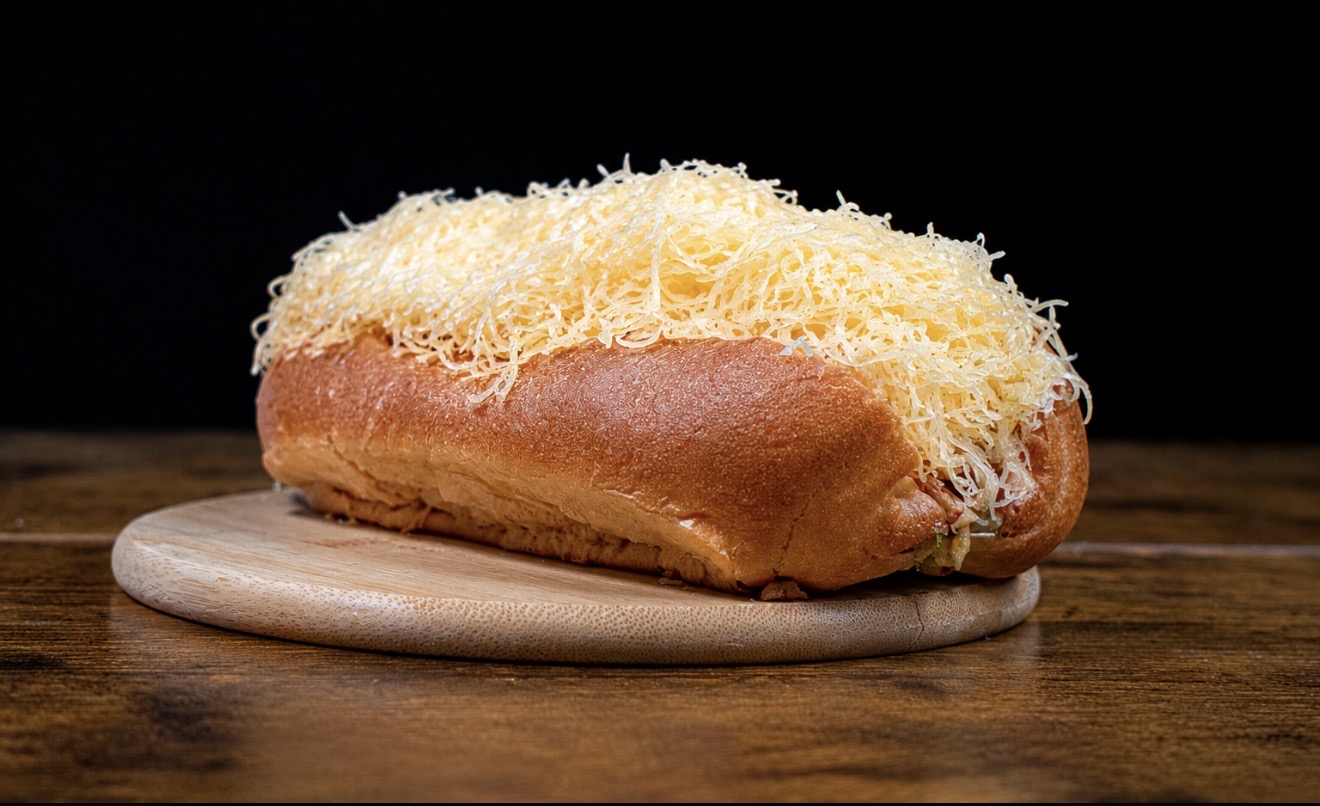 Golden brioche loaf topped with shredded cheese